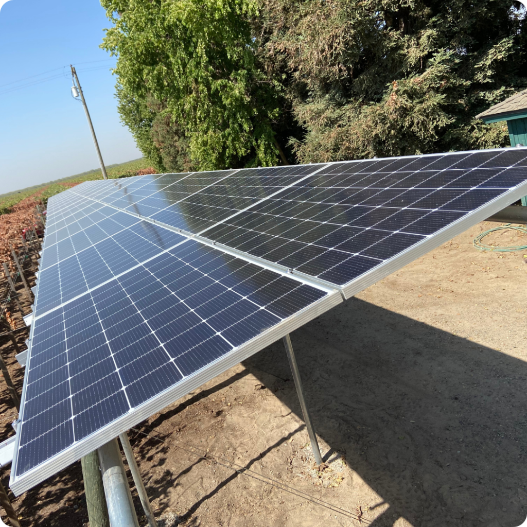 Ground Mount Solar Installation: A side view of a ground mounted solar panel in an agricultural field.