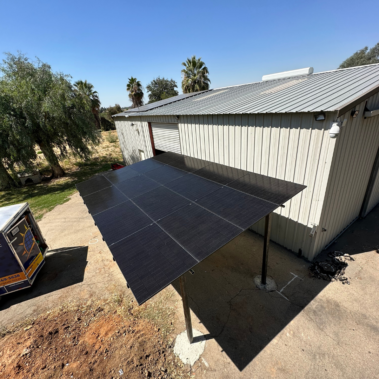 a solar patio attached to the side of a building as an extension