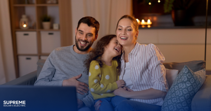 Why is it a Good Idea to Combine Solar Panels With a Generator? A family sits inside a cozy home at night.