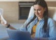 Avoid These 7 Common Mistakes When Installing Solar Panels in Fresno. A woman smiles as she checks her savings on her energy bill and bank account online.
