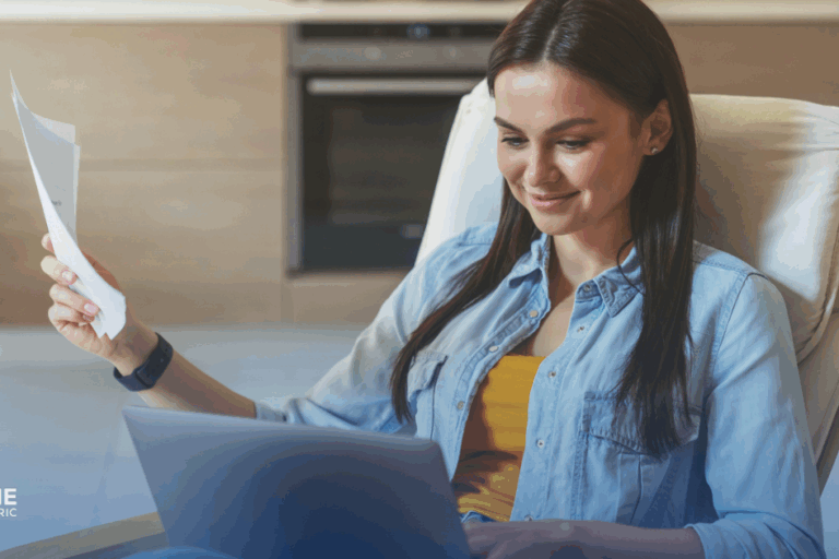 Avoid These 7 Common Mistakes When Installing Solar Panels in Fresno. A woman smiles as she checks her savings on her energy bill and bank account online.