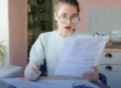 Fresno Has Highest Electric Bills in the Nation: How Solar Can Help Reduce Your Costs. Amazed woman looks at her electric bill.