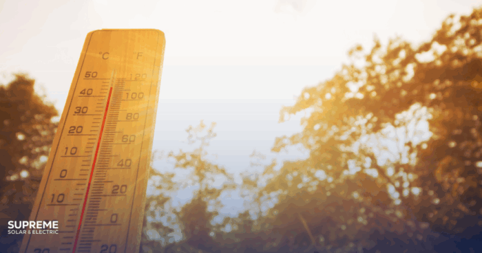 Fresno Heat and Solar Panels Do High Temperatures Affect Efficiency? A thermometer with a sunny background outside with trees in the background.